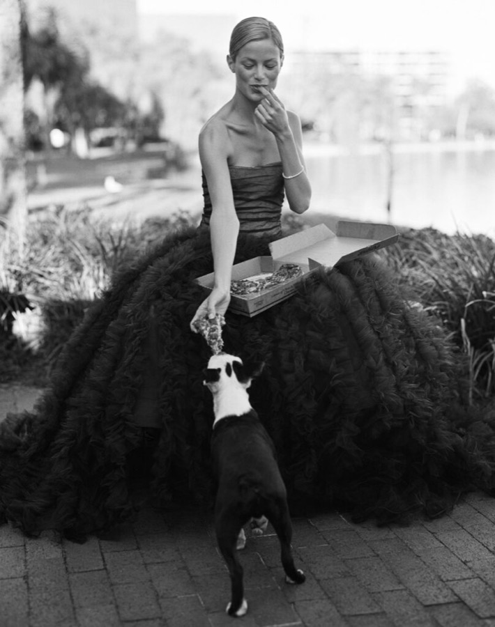 Carolyn Murphy sharing a pizza with her dog, Orlando, Florida